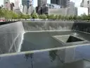 The 9/11 Memorial pool with water falling into the centre