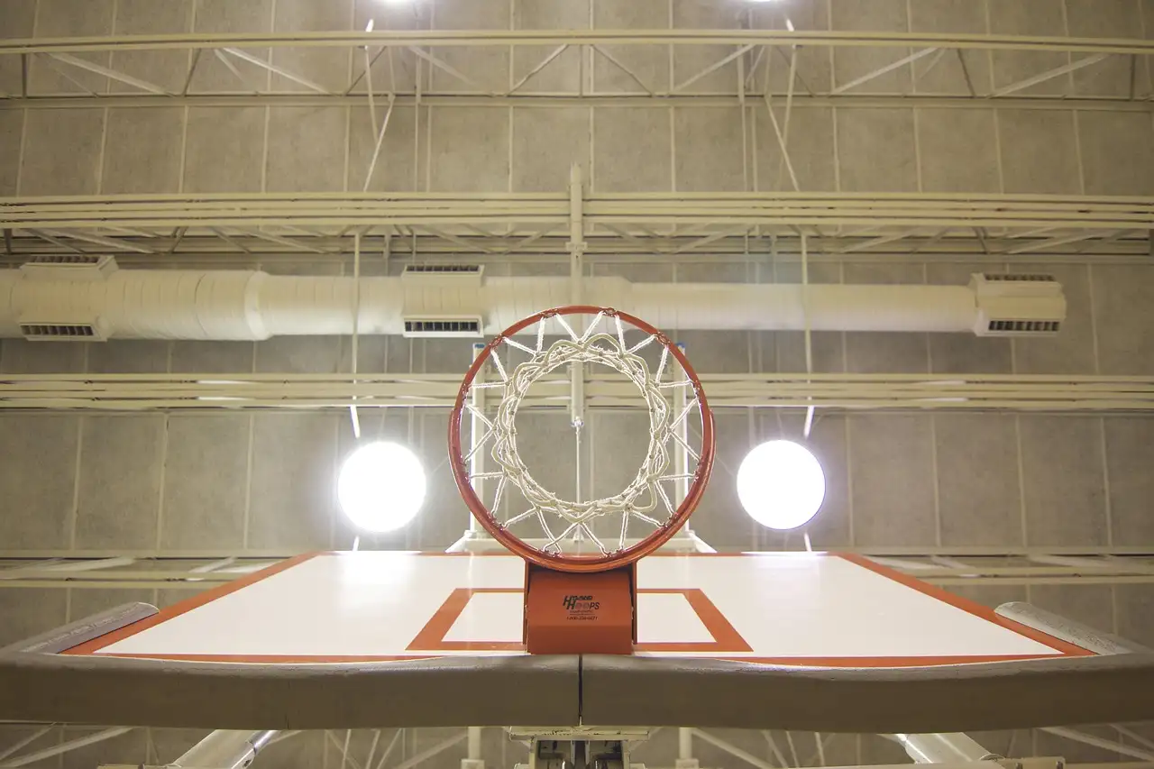 A basketball hoop under bright lights