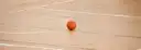 A basketball on a hardwood court