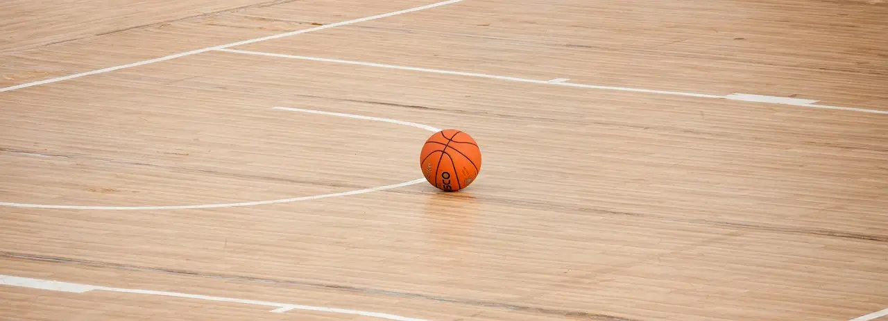 A basketball on a hardwood court