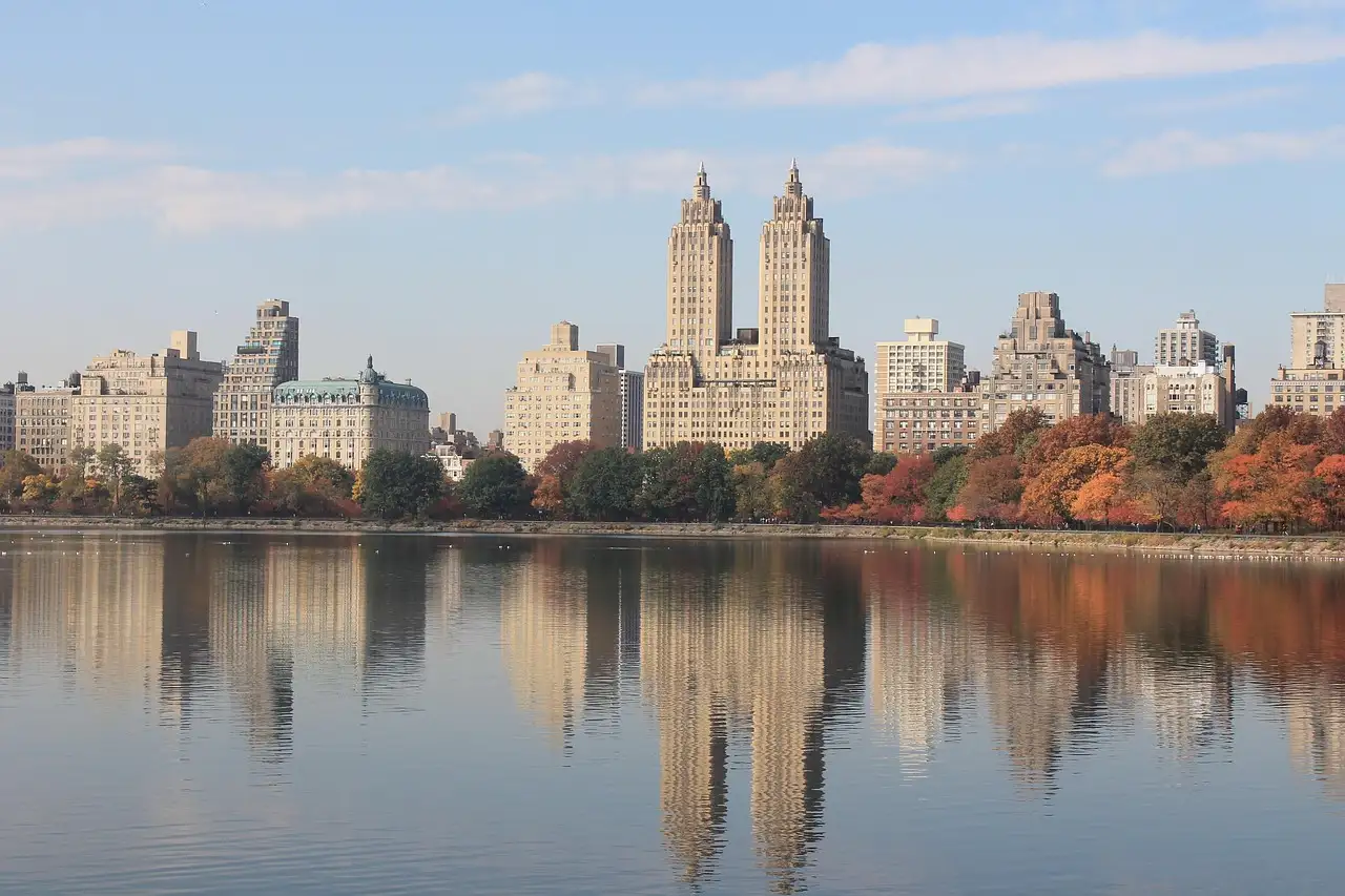 Autumn trees and the twin towers of the San Remo reflected in Central Park's reservoir