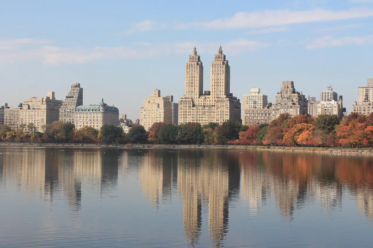 Autumn trees and the twin towers of the San Remo reflected in Central Park's reservoir