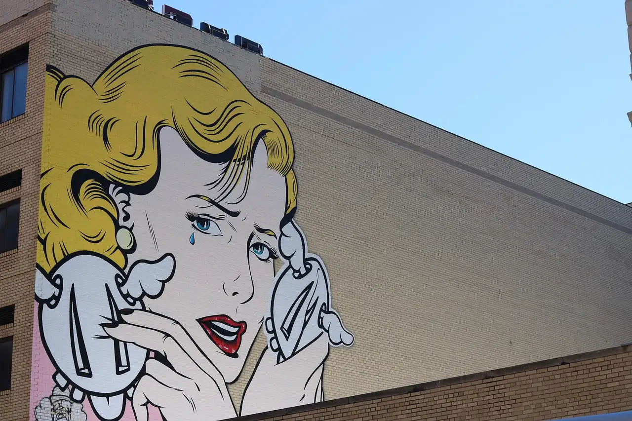 A comic-style pop-art mural of a woman on a Brooklyn wall