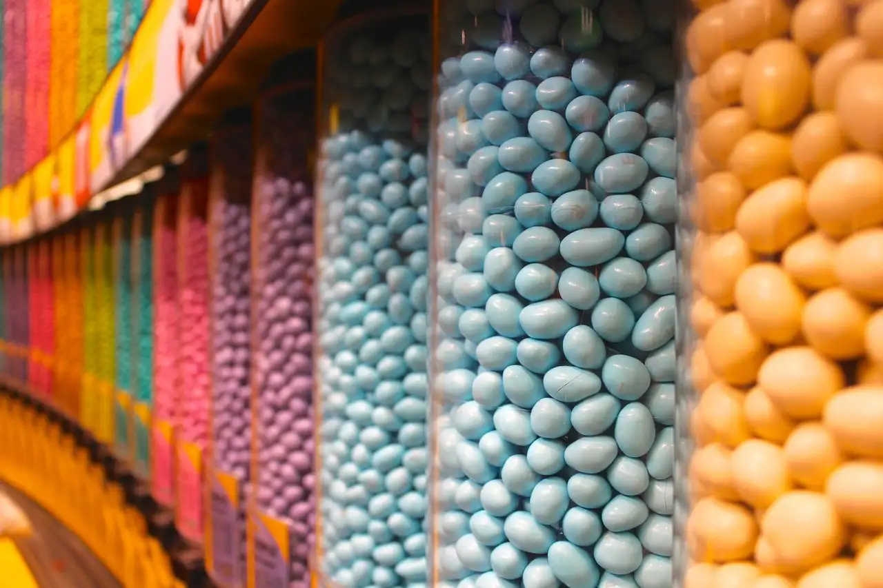 A wall of candy dispensers in a sweet shop