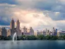 The Central Park reservoir fountain with Upper West Side towers behind