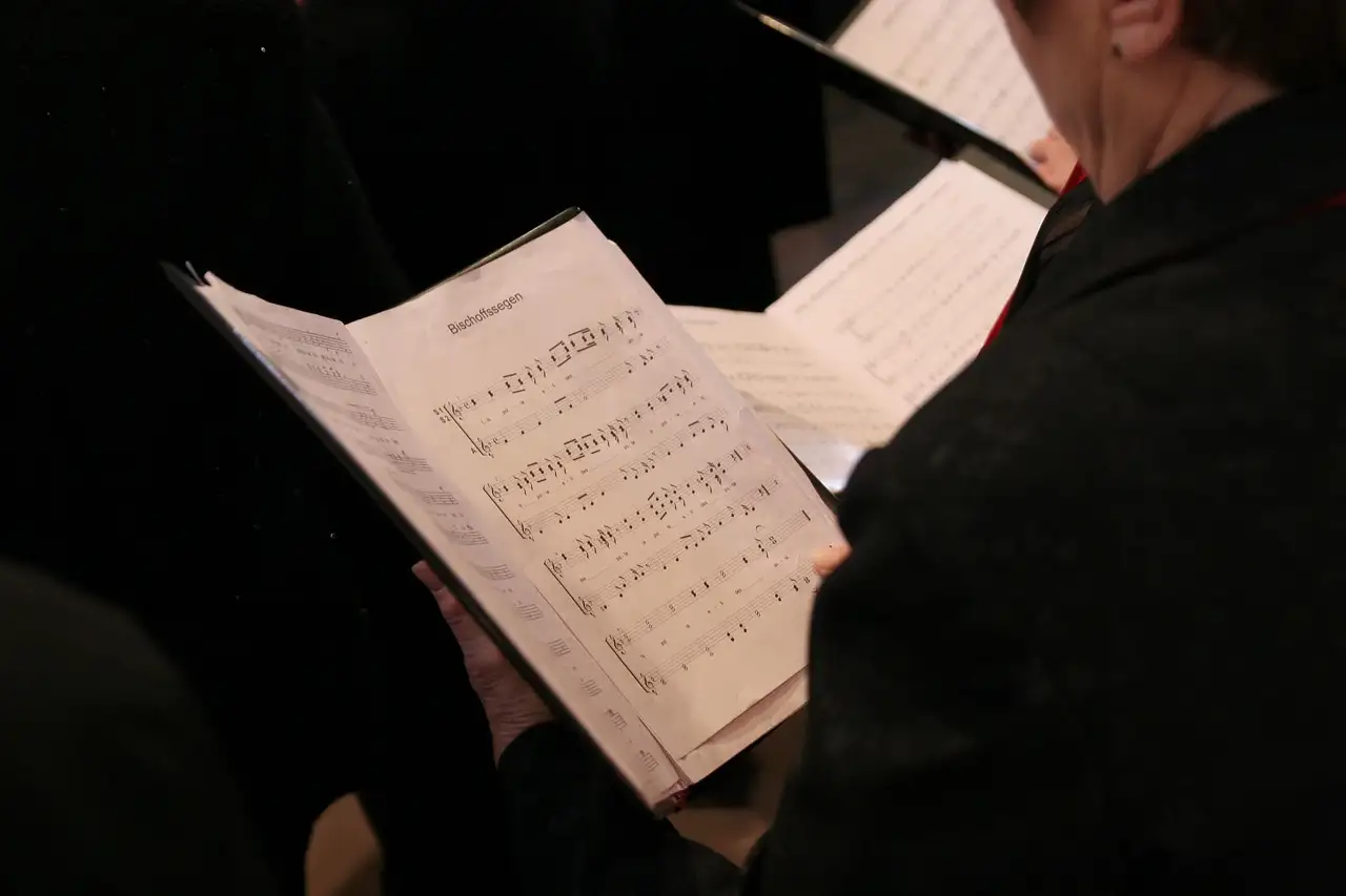 Choir singers holding sheet music