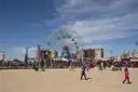 The Wonder Wheel and the Coney Island boardwalk seen from the beach on a sunny day
