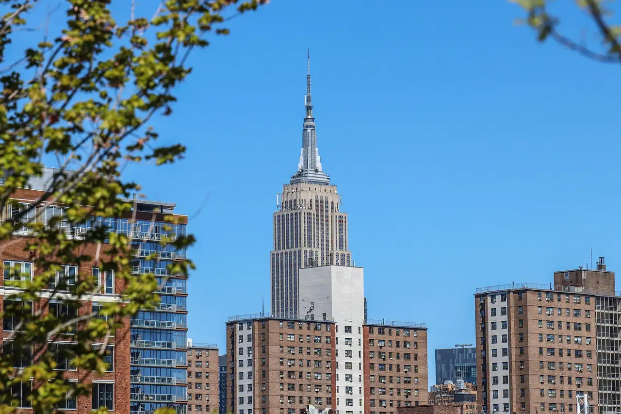 The Empire State Building seen from a street lined with trees