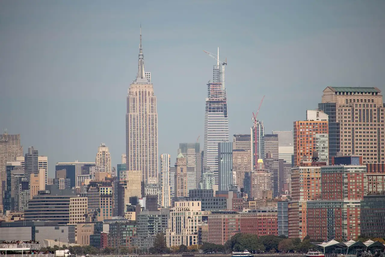 The Empire State Building above the skyline, seen from across the river