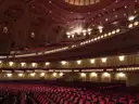 A grand auditorium with ornate balconies