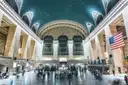 Grand Central's main concourse with the US flag and the big windows