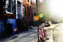 A Greenwich Village street with a parked bike at sunset