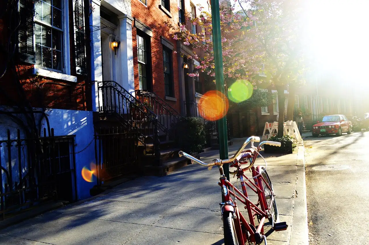 A Greenwich Village street with a parked bike at sunset