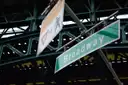 A Broadway street sign under the elevated subway line in Harlem