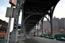 A Harlem street under the arches of the elevated subway viaduct