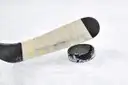 An ice hockey stick and puck on the ice
