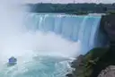Horseshoe Falls with mist and a boat