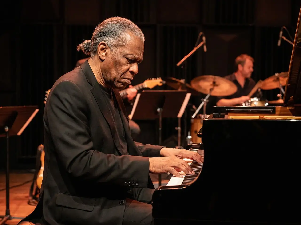 A jazz pianist and drummer on stage
