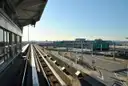 The AirTrain JFK track running past a terminal at JFK Airport on a clear evening