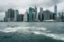 Lower Manhattan seen from a boat on choppy water