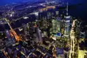 Lower Manhattan lit up at night, seen from the air