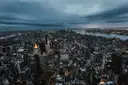 Manhattan seen from high above at dusk, with the Hudson River on the right