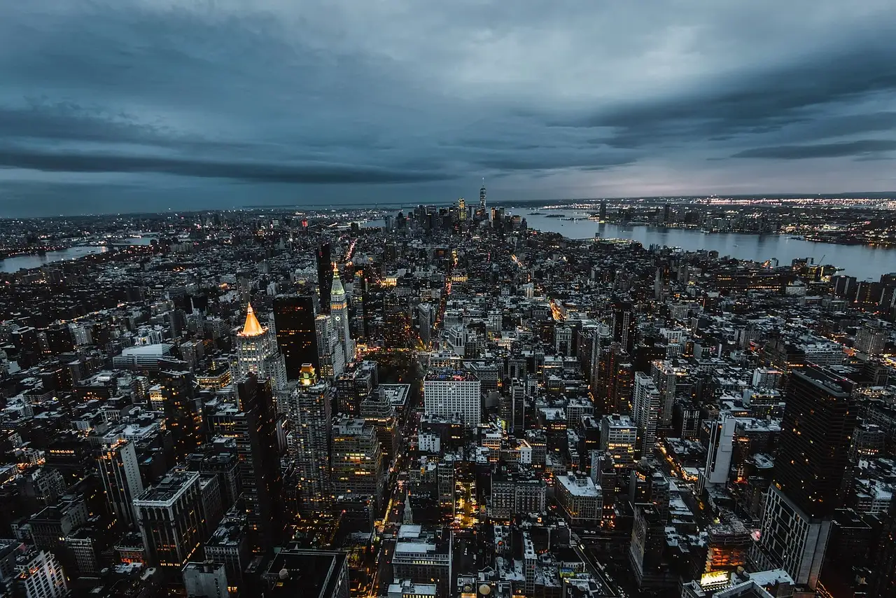 Manhattan seen from high above at dusk, with the Hudson River on the right