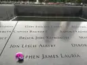 Names on the memorial panel with a flower