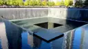 The memorial pool ringed by trees