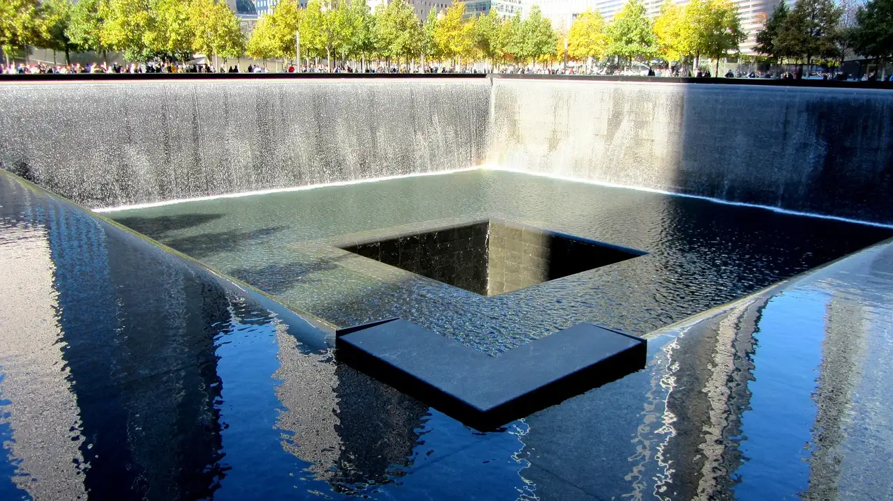 The memorial pool ringed by trees