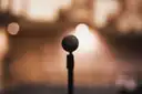 A microphone in warm stage light