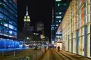 A Midtown avenue at night with the Empire State Building lit at the end
