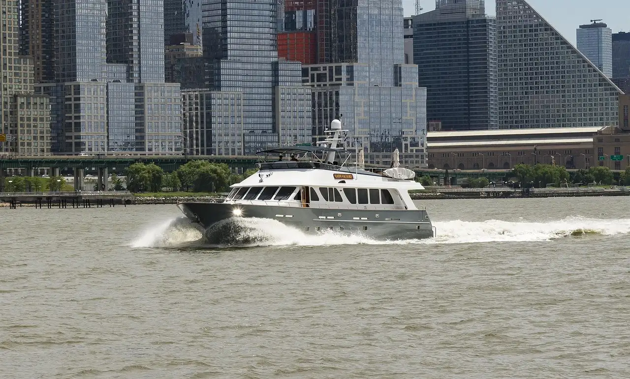 A motor yacht cruising past Lower Manhattan