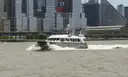 A motor yacht cruising past Lower Manhattan