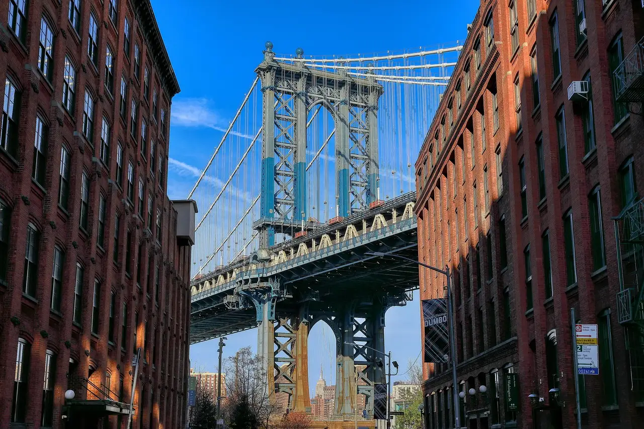The Manhattan Bridge framed by red-brick warehouse buildings on Washington Street in DUMBO, Brooklyn