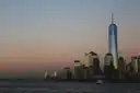 One World Trade Center at dusk across the water