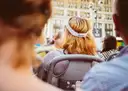 Riders on the open top deck of a sightseeing bus in New York