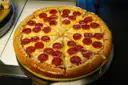 A pepperoni pizza cut into slices
