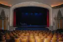 A proscenium stage framed by heavy curtains