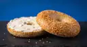 A sesame bagel with cream cheese