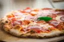 A stone-oven pizza with salami