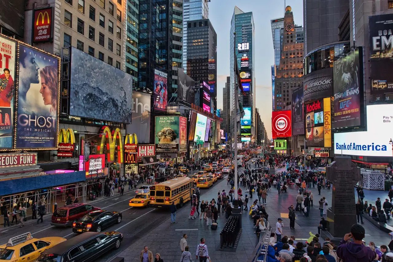 Times Square seen from above, with screens, crowds and taxis