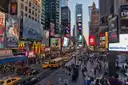 Times Square seen from above, with screens, crowds and taxis