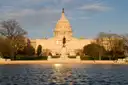 The US Capitol reflected in the pool at sunset