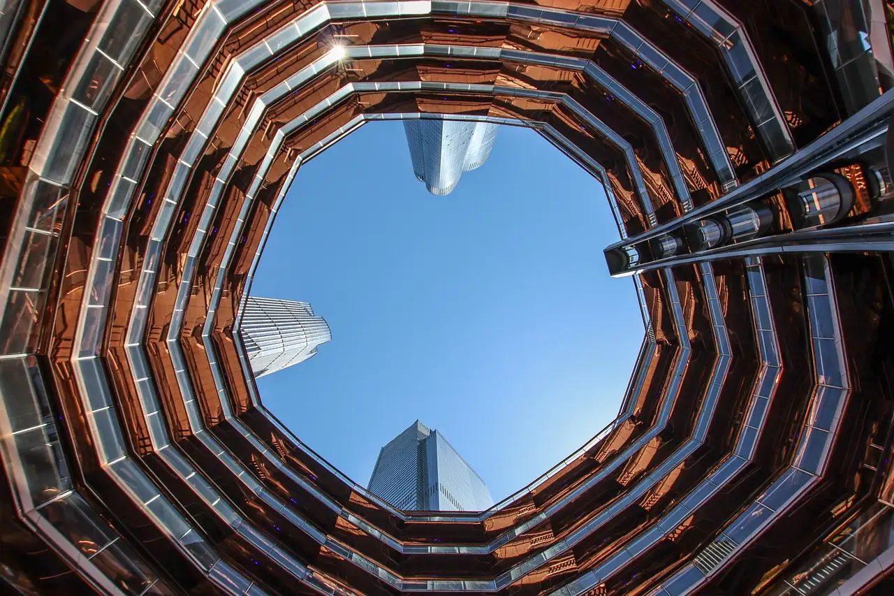 Looking up through the Vessel to the Hudson Yards towers