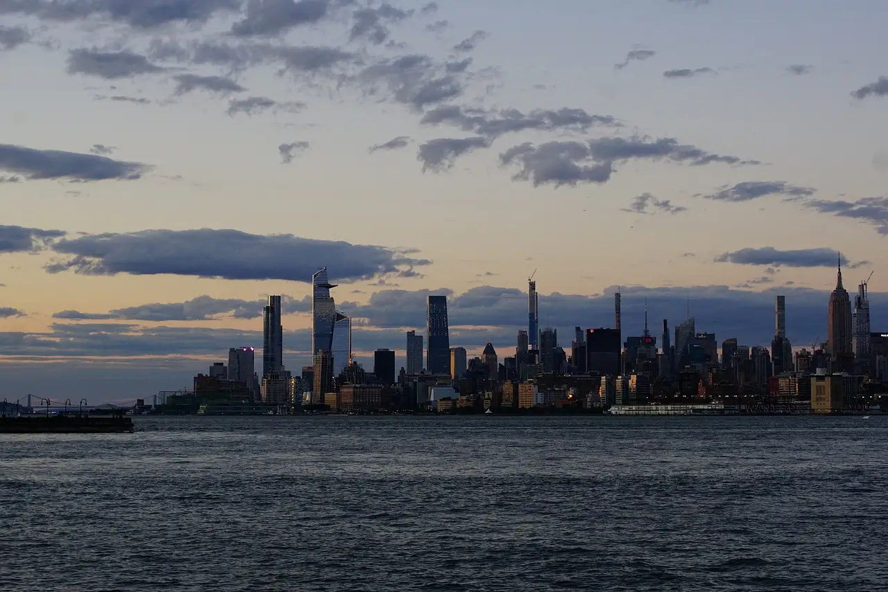 The Midtown Manhattan skyline, with the Hudson Yards towers and the Empire State Building, across the Hudson River at dusk