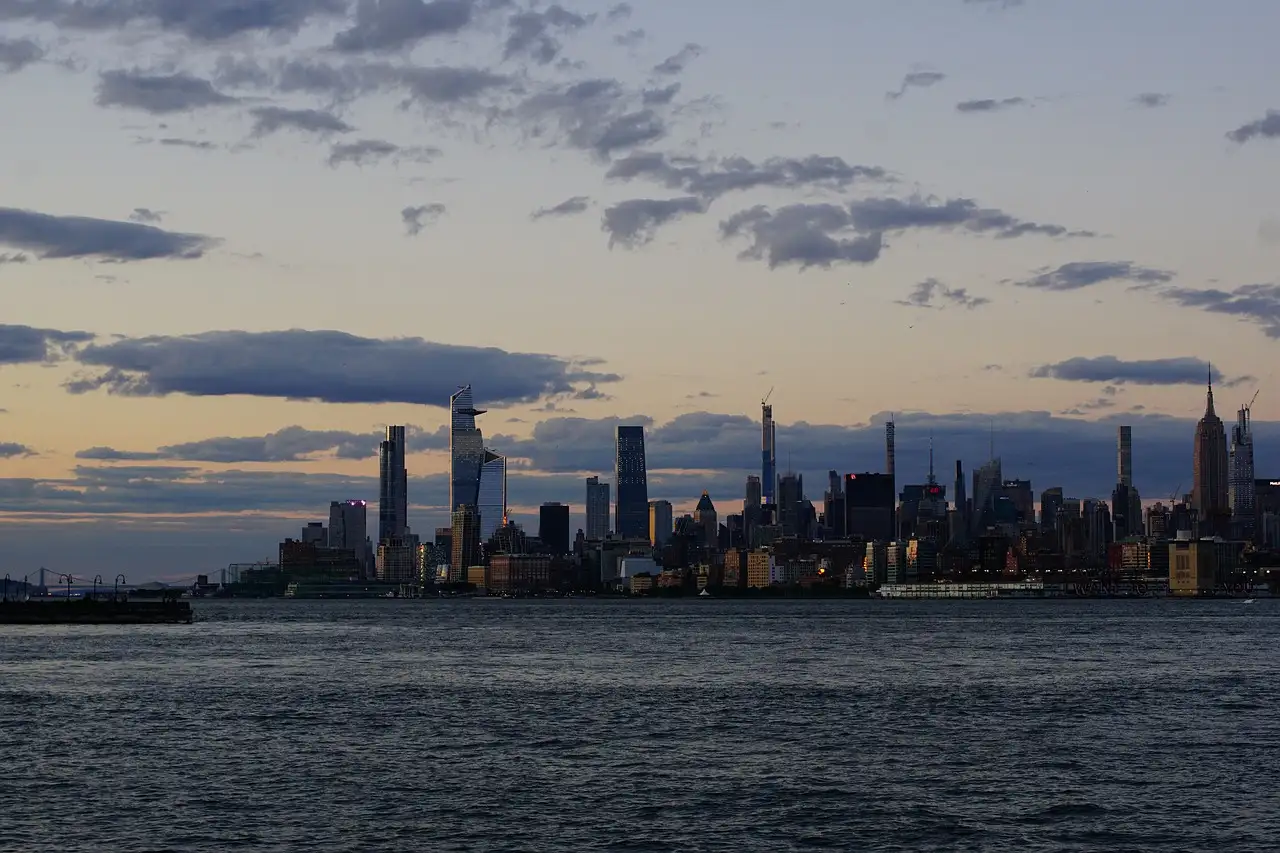 The Midtown Manhattan skyline, with the Hudson Yards towers and the Empire State Building, across the Hudson River at dusk