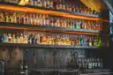Bottles on an old wooden back bar